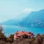 Picturesque view of a house overlooking Lake Garda near Malcesine with mountains in the background.