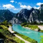 Beautiful view of turquoise lake and rugged mountains in Italy, perfect for travel inspiration.