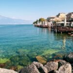 Idyllic view of Gardone Riviera with clear turquoise water and charming architecture. Perfect for travel inspiration.