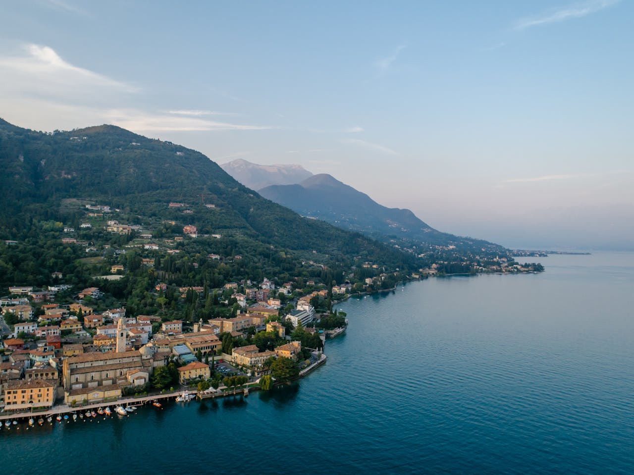 Scenic aerial view of a charming lakeside town along the coast of Lake Garda, Italy.