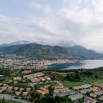 Scenic aerial shot of Salo, Italy with Lake Garda and mountains in summer.