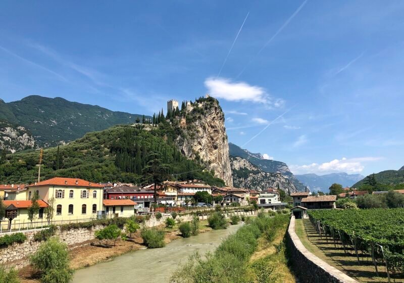 Arco's houses along the River Sarca below the castle on its limestone crag