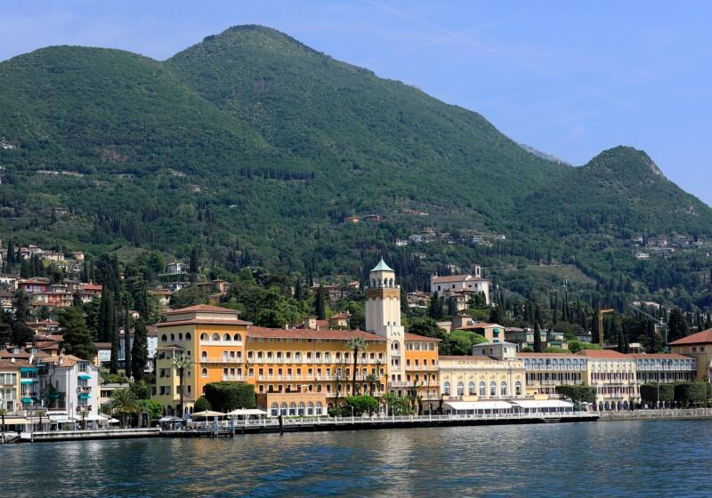 Gardone Riviera from the lake, with the Grand Hotel on the waterfront below wooded hills